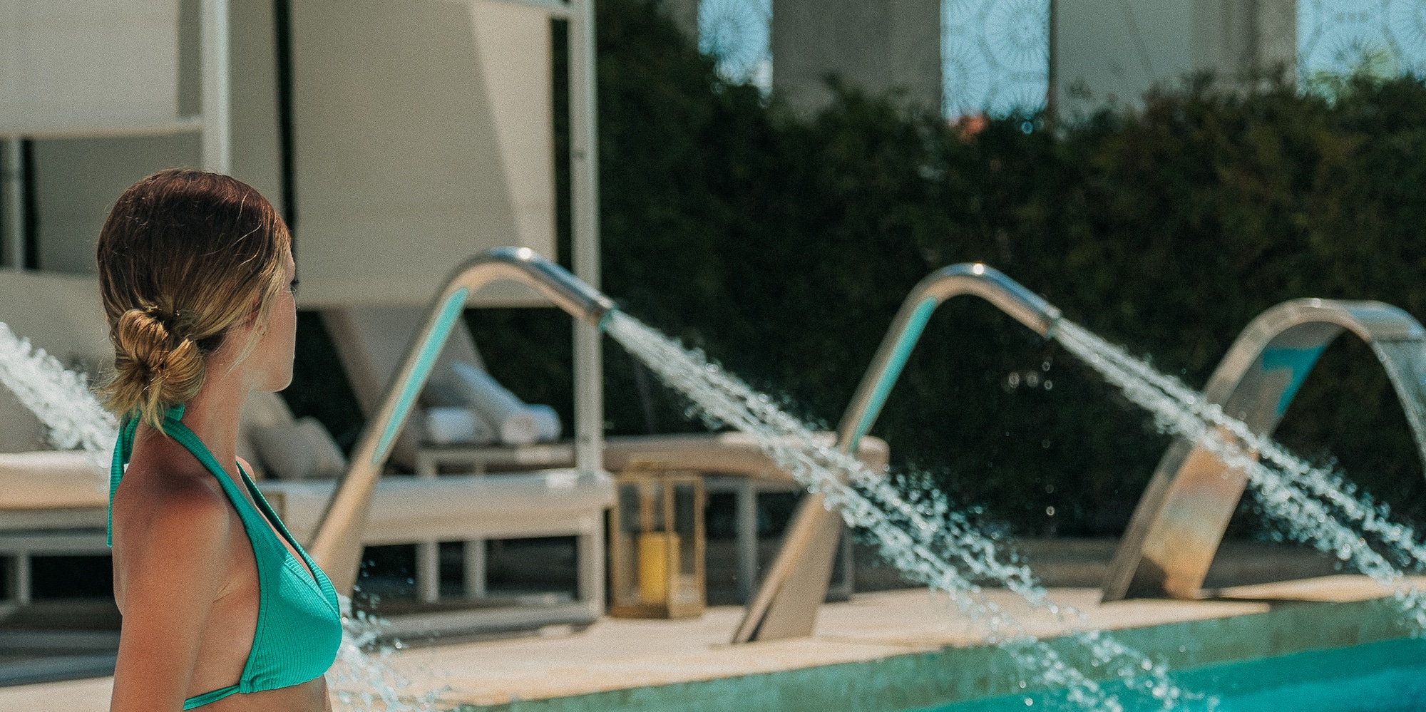 a woman in a garment standing in a pool