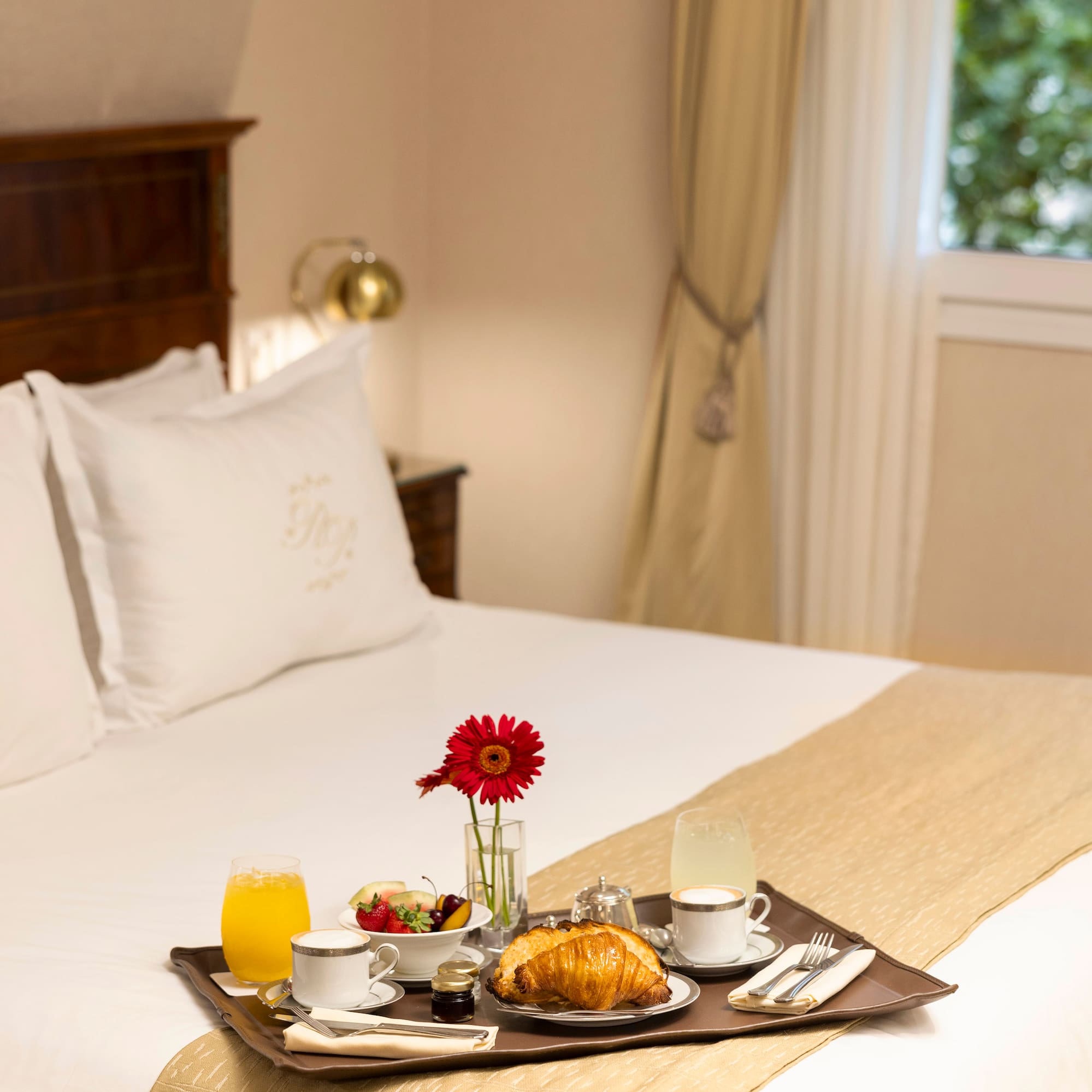 a tray of breakfast on a bed