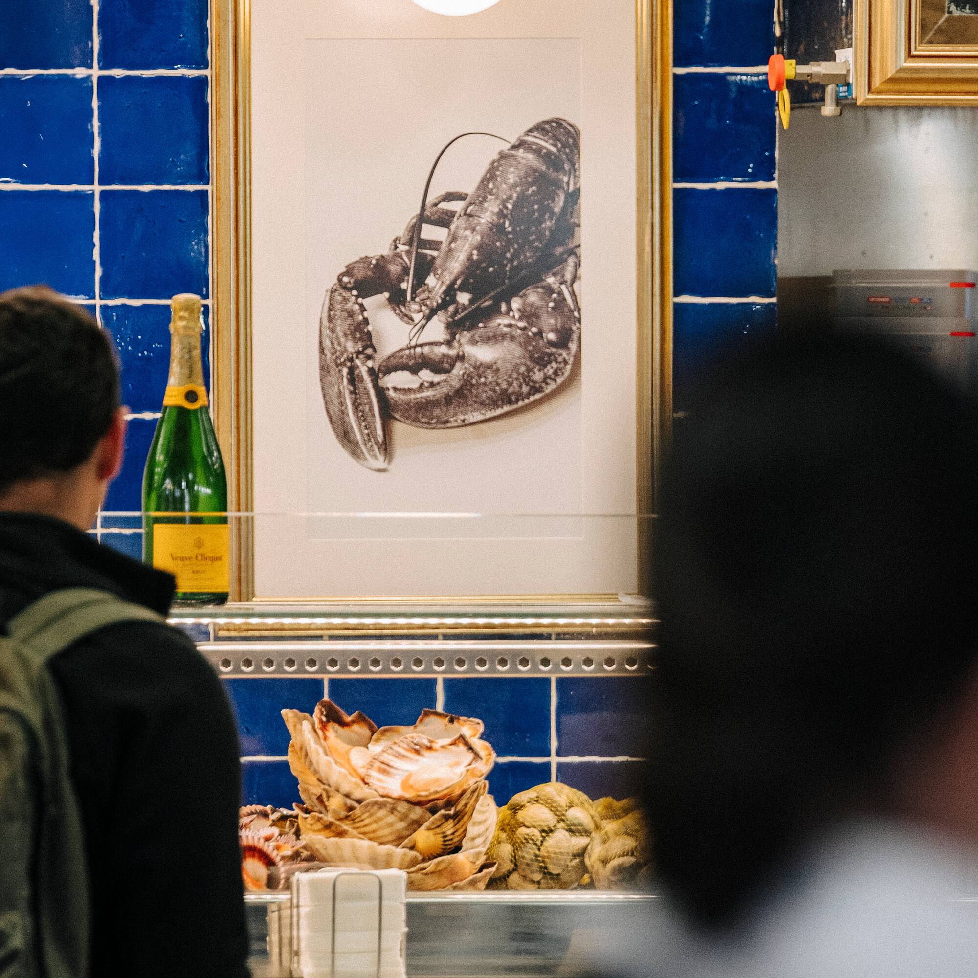 a man looking at a picture of a lobster
