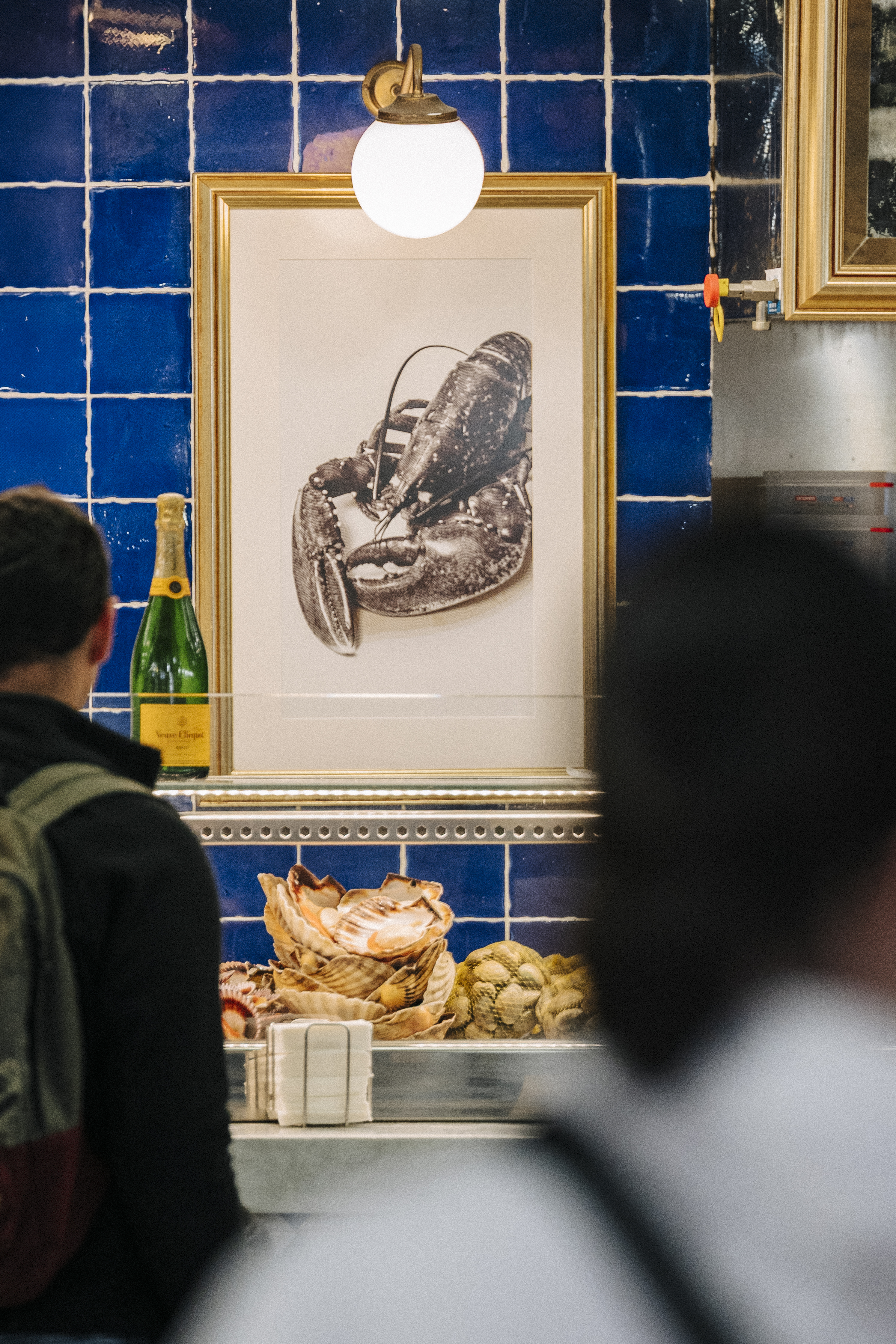 a man looking at a picture of a lobster
