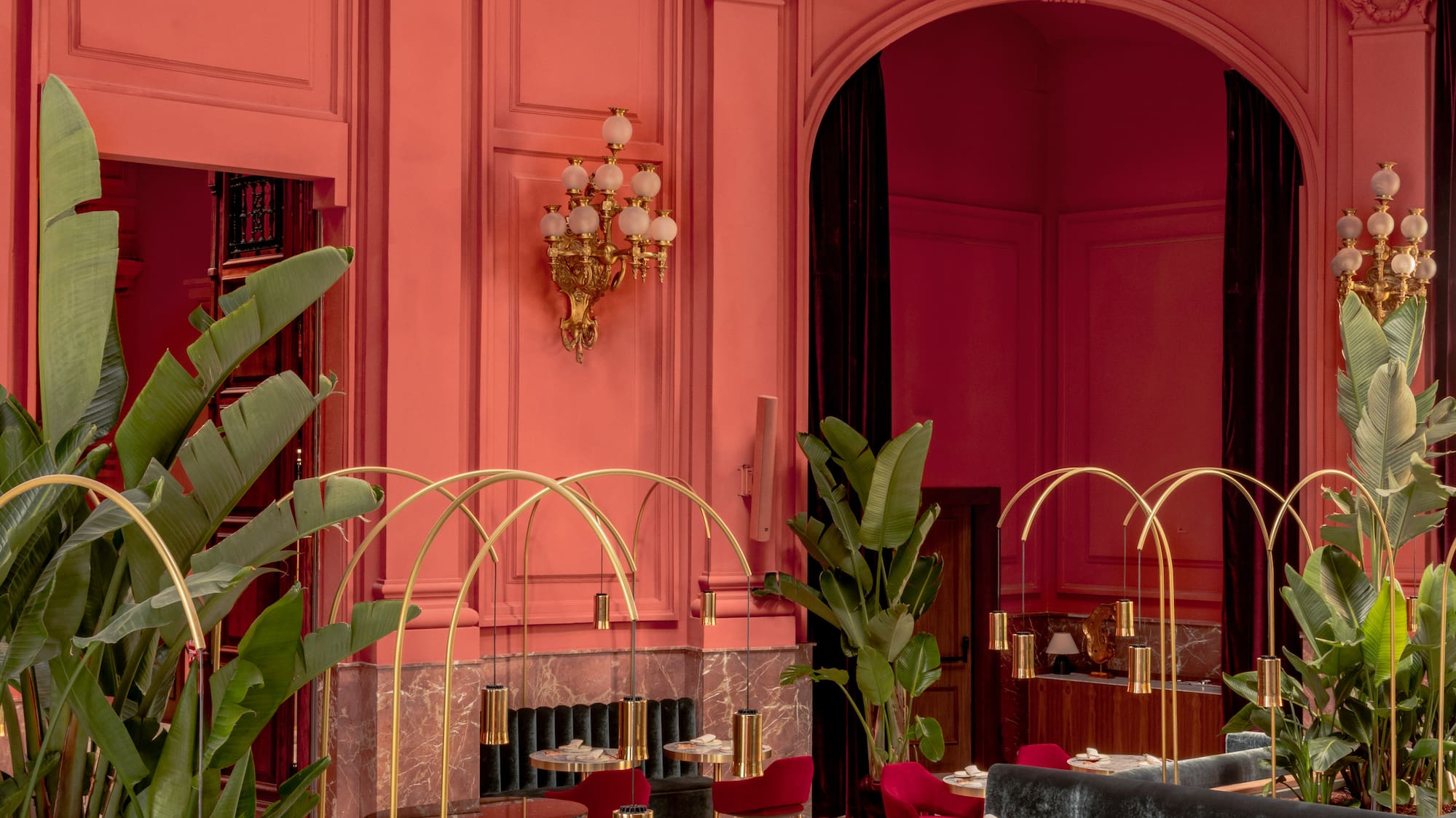 a room with tables and chairs and plants