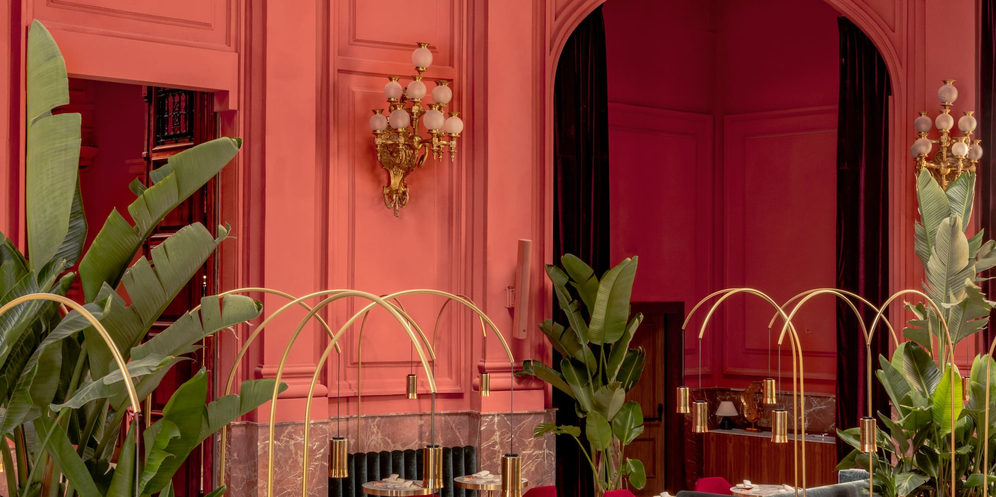 a room with tables and chairs and plants