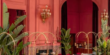 a room with tables and chairs and plants