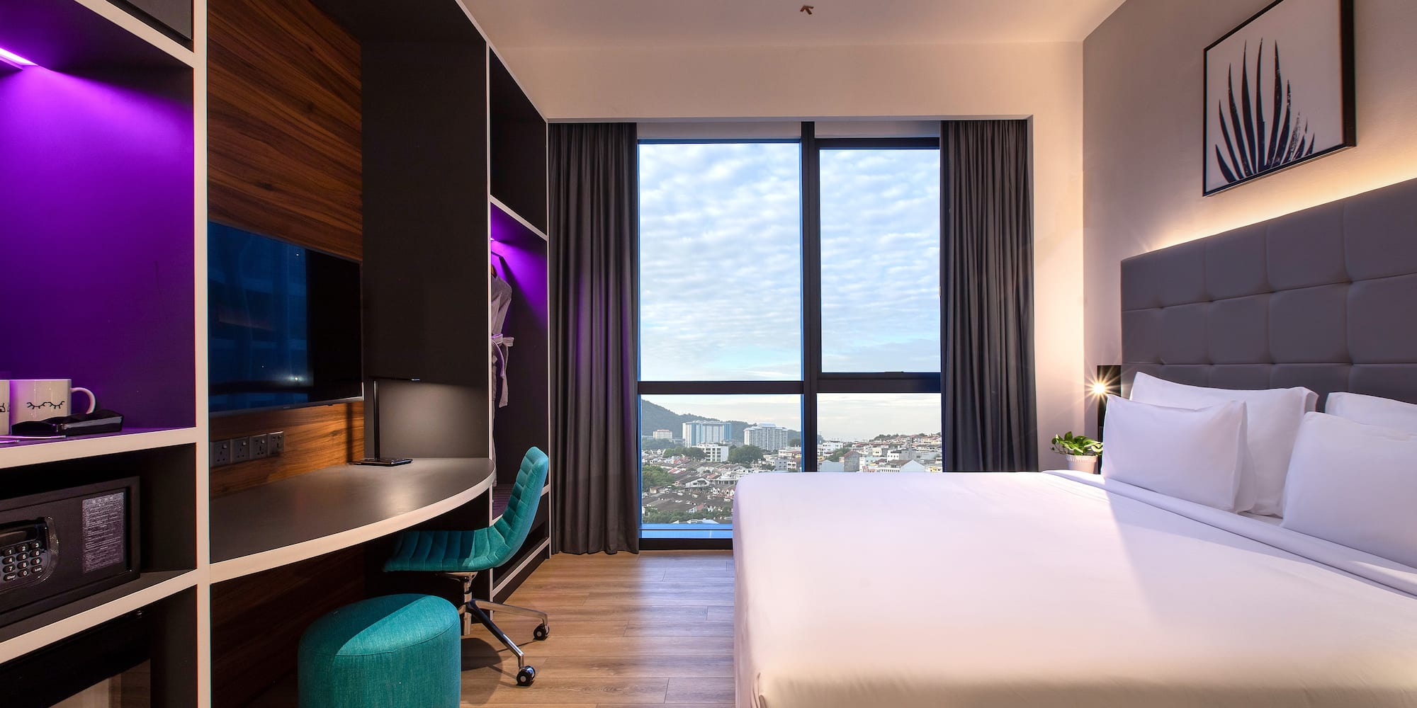 a room with a large window and a bed