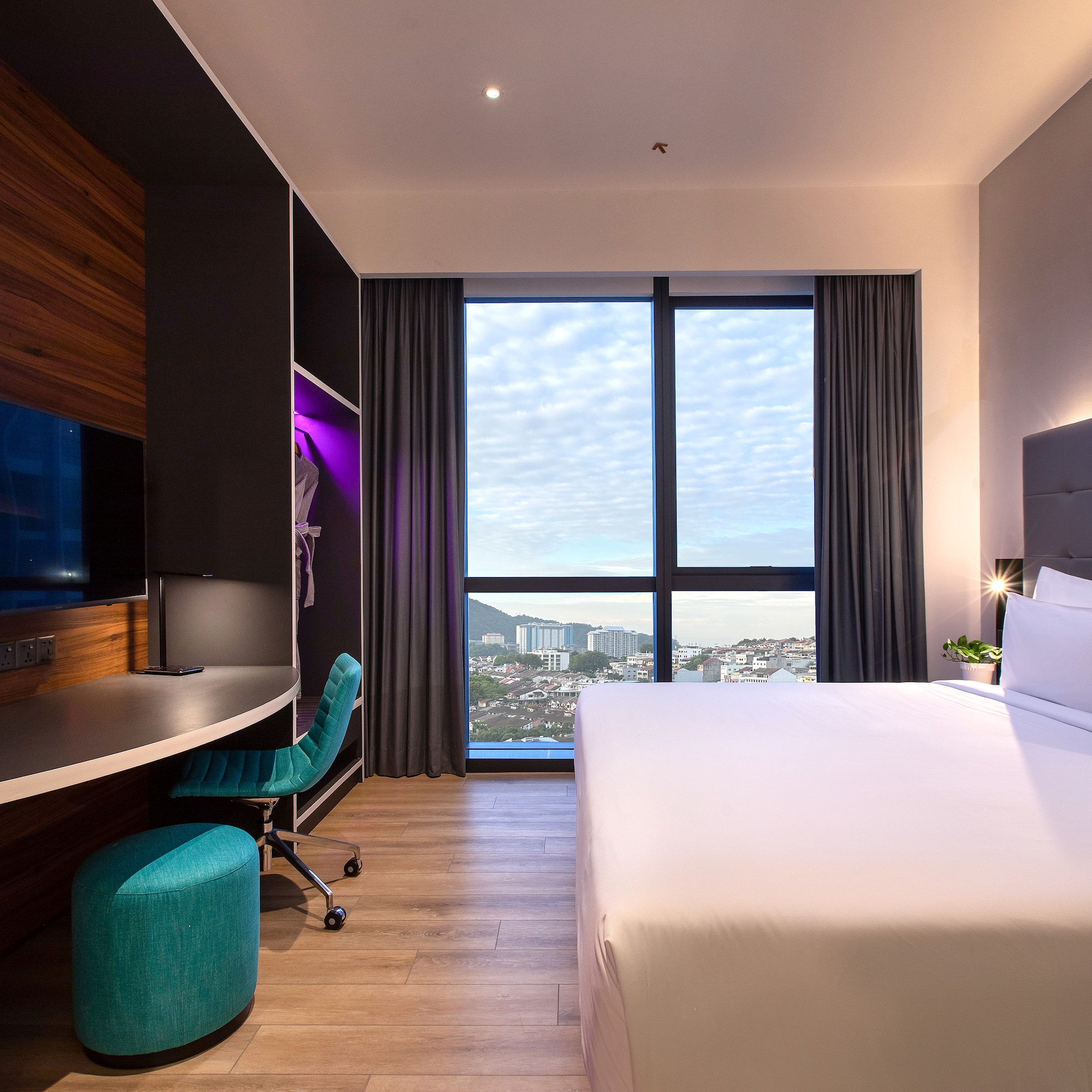 a room with a large window and a bed