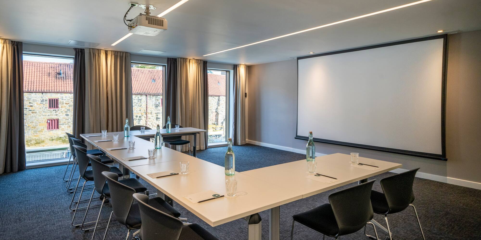 a room with a large table and chairs