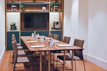 a conference room with a table and chairs