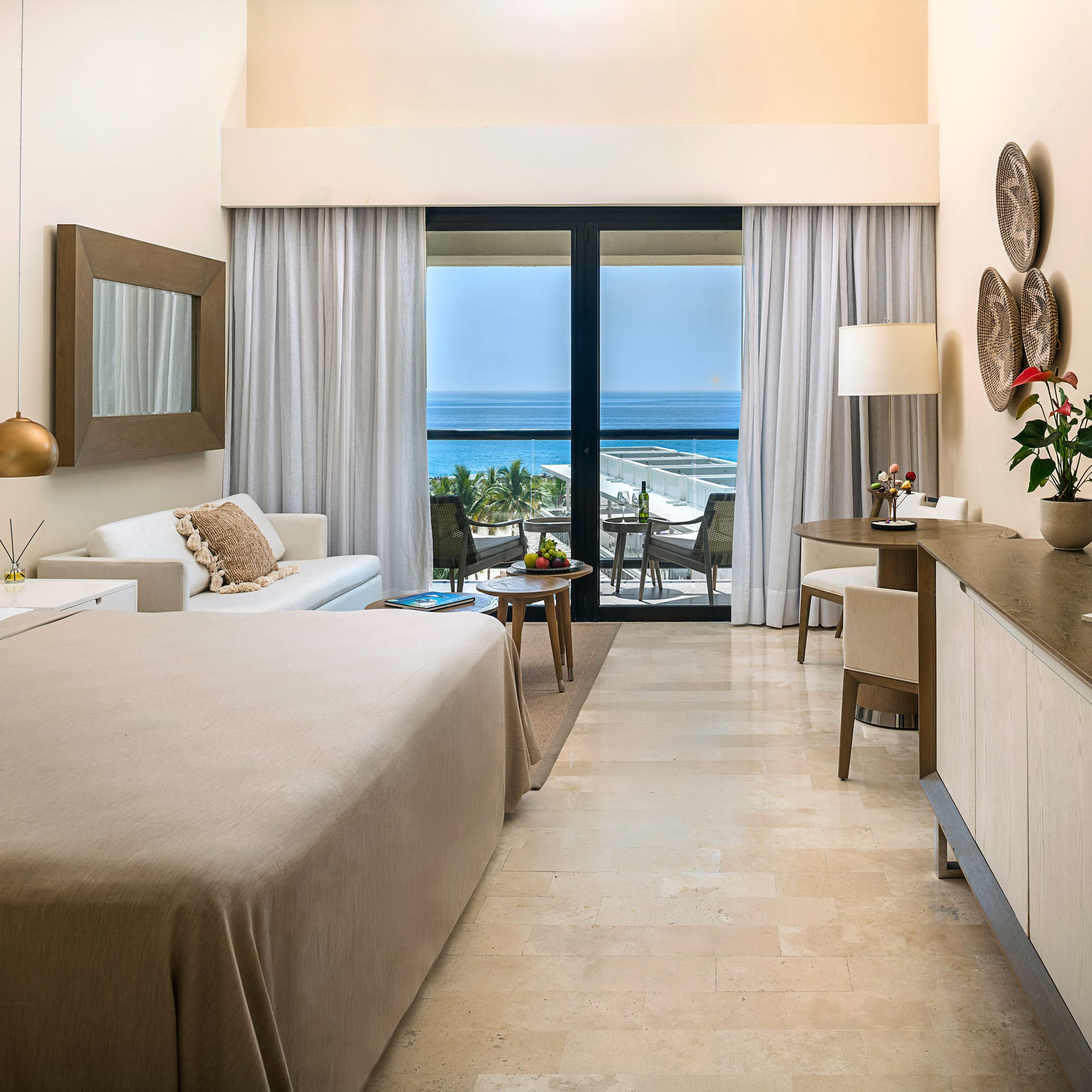 a room with a bed and a table and chairs