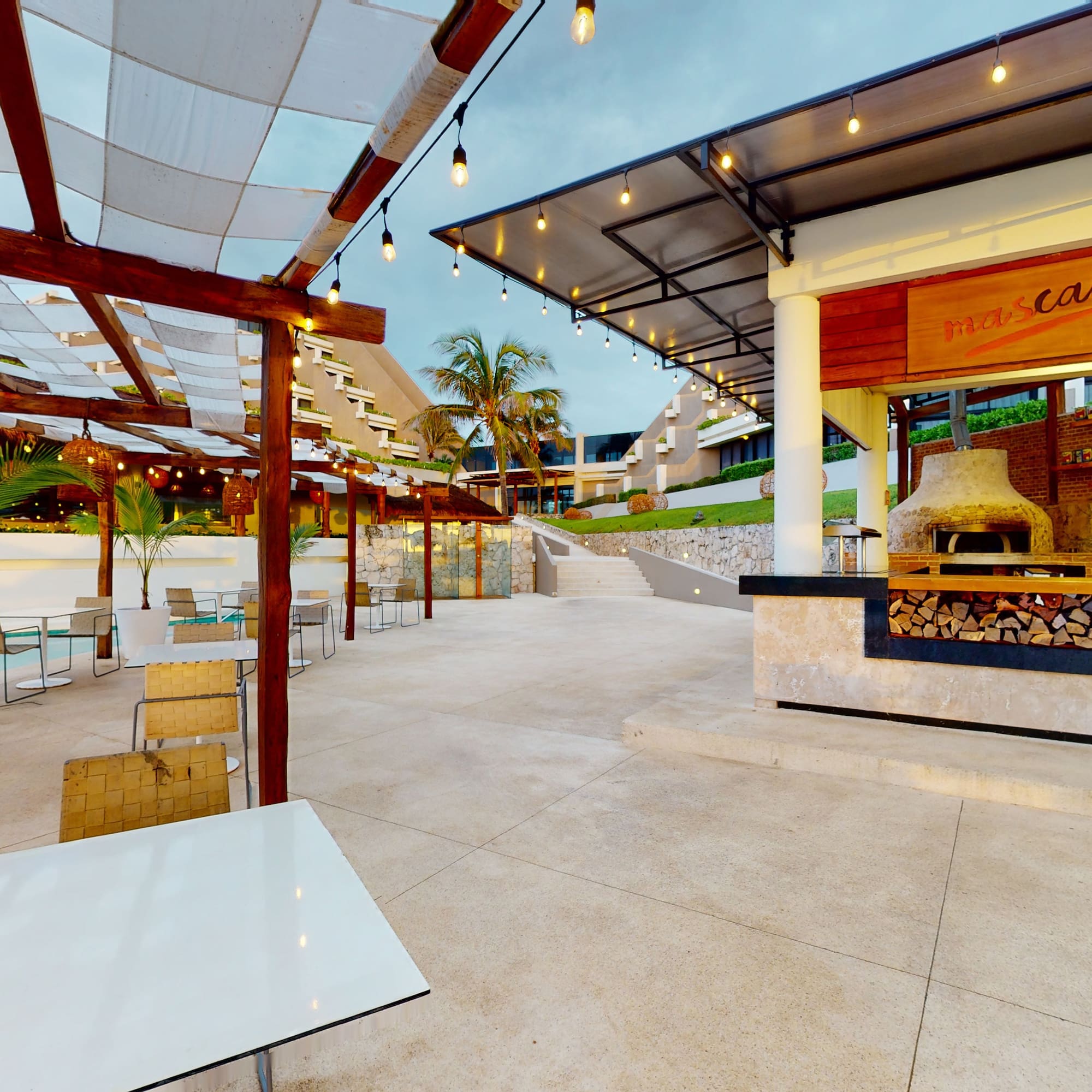 a patio with tables and chairs