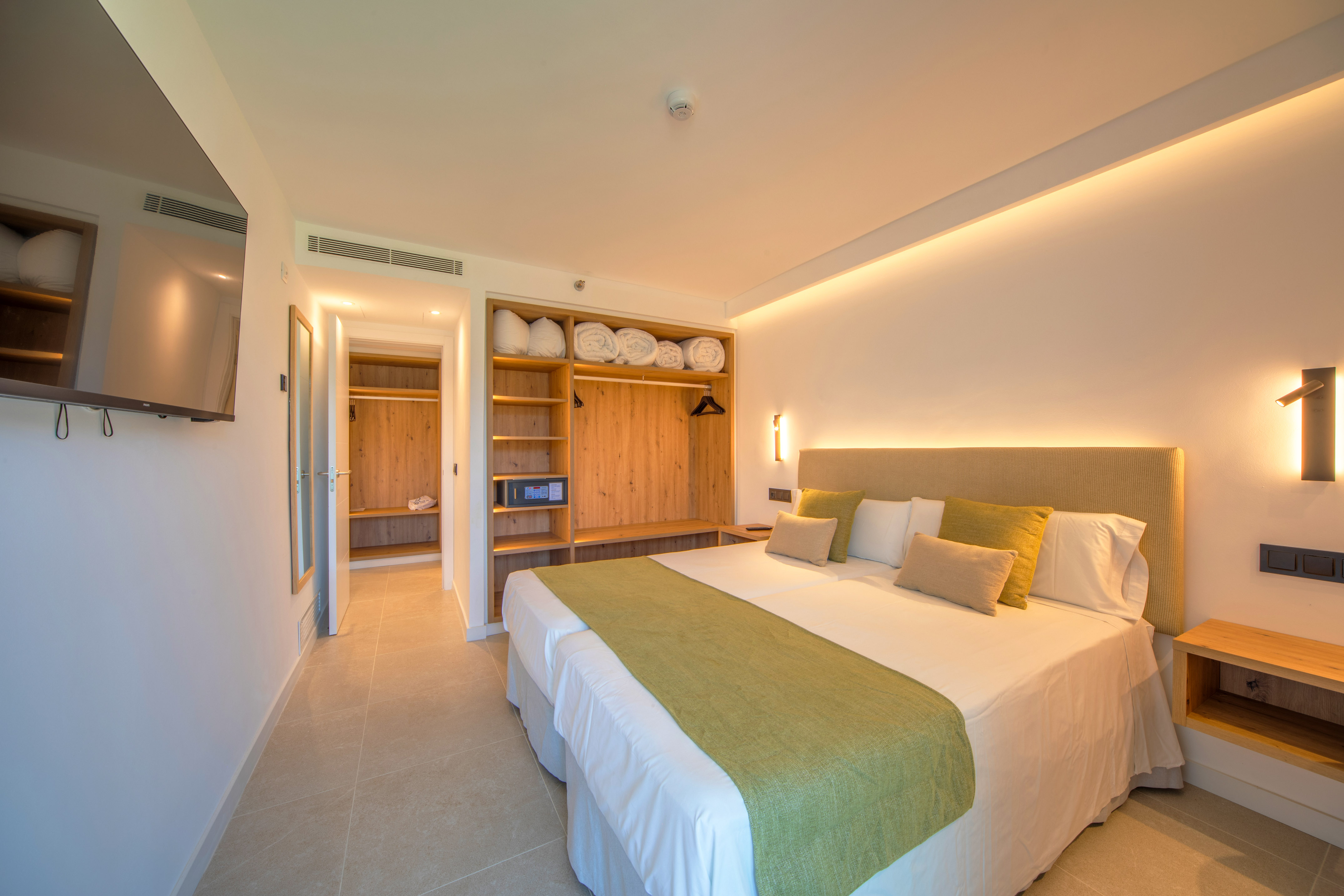 a room with a bed and shelves