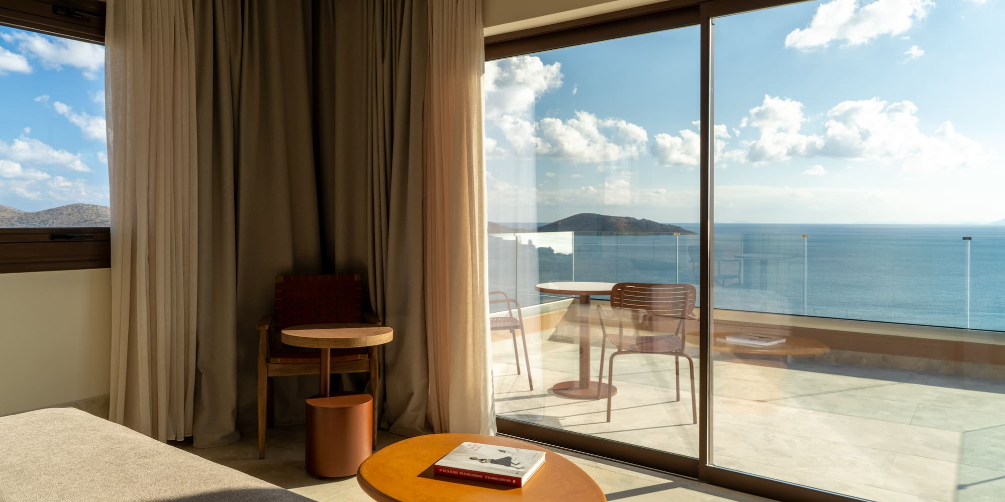 a room with a view of the ocean from the window