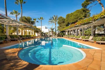 a pool with a deck and trees