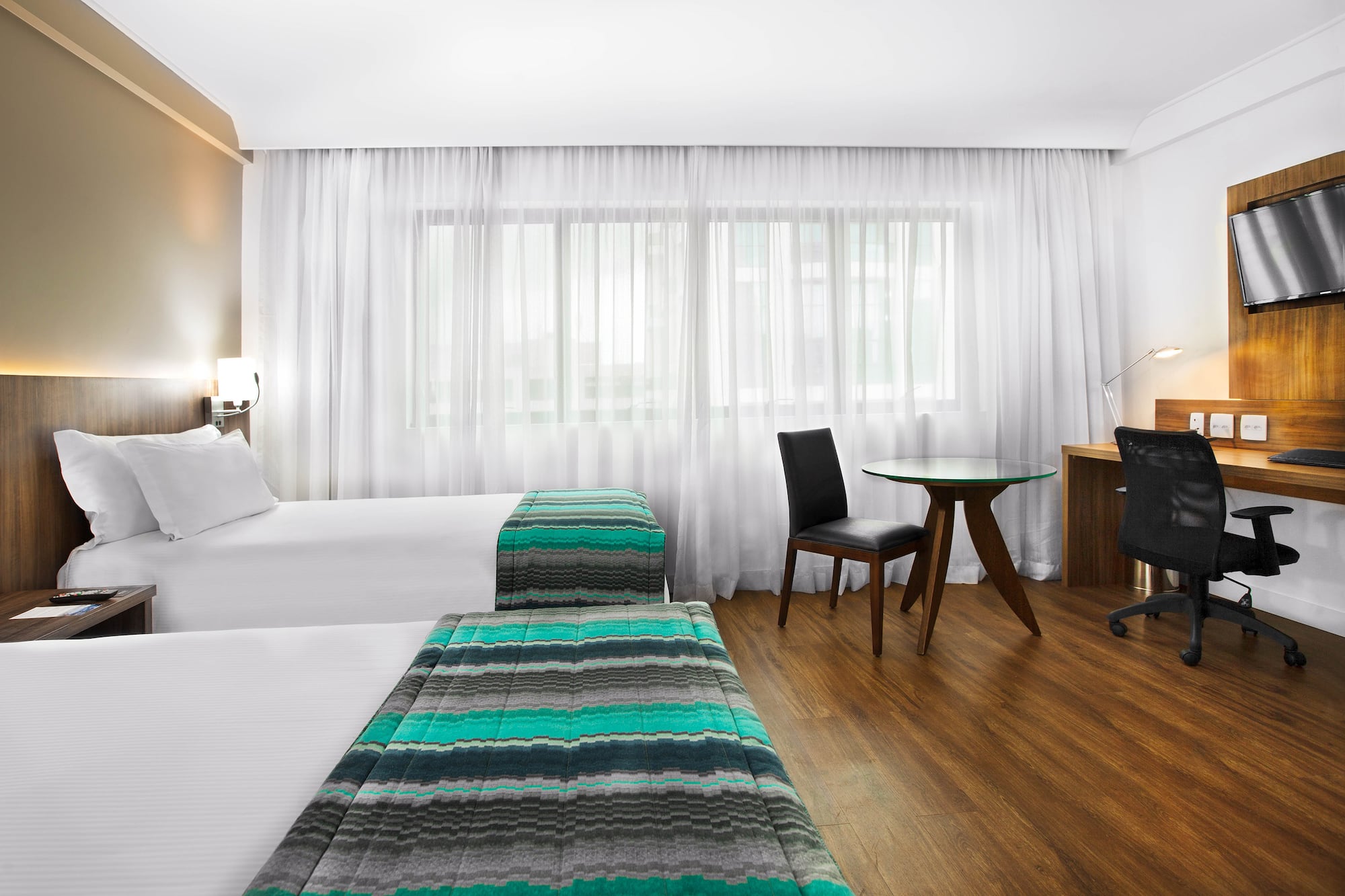 a room with two beds and a desk