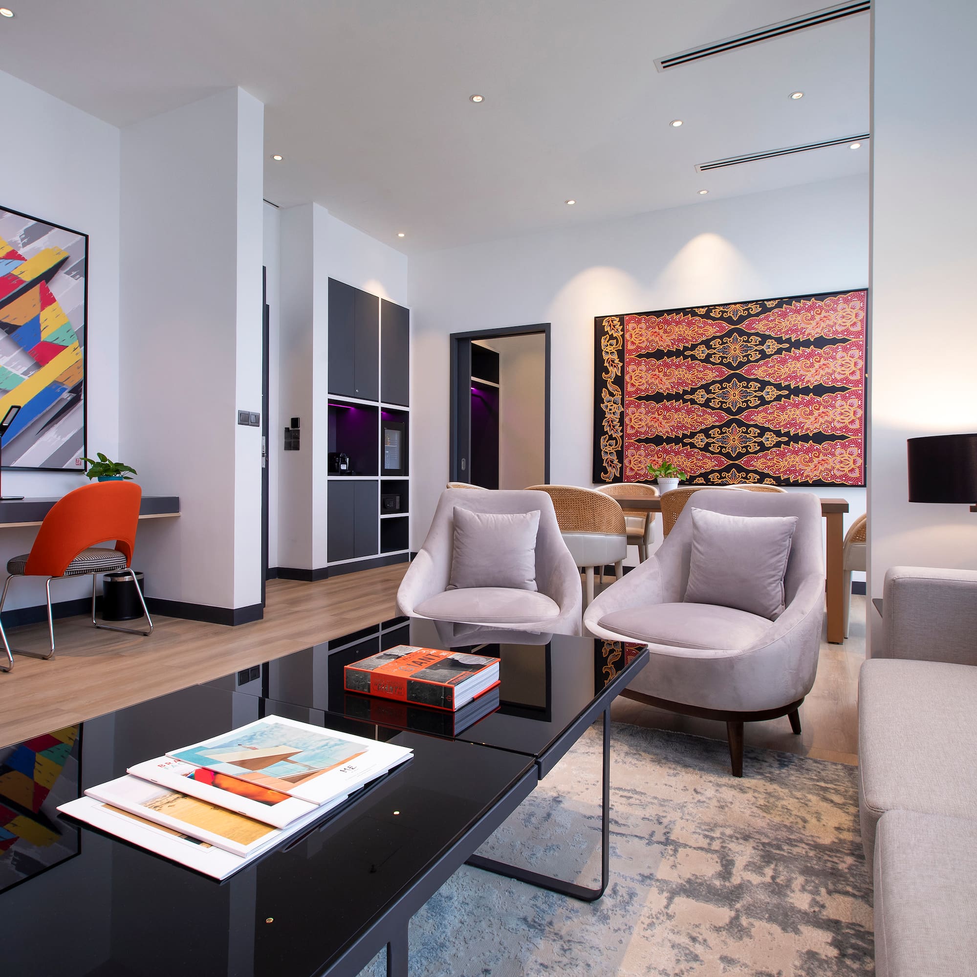 a room with a black coffee table and chairs