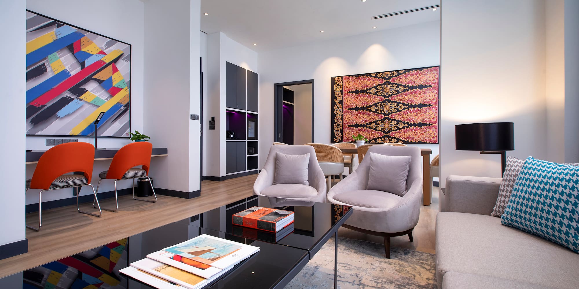 a room with a black coffee table and chairs