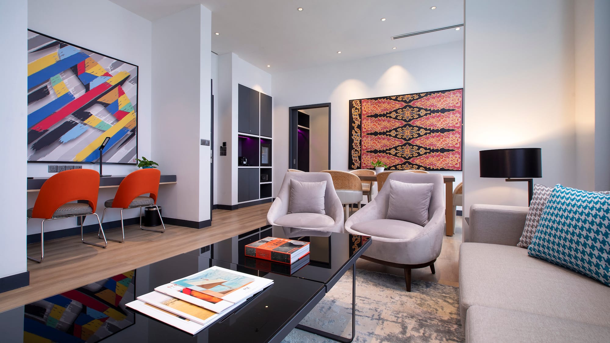 a room with a black coffee table and chairs