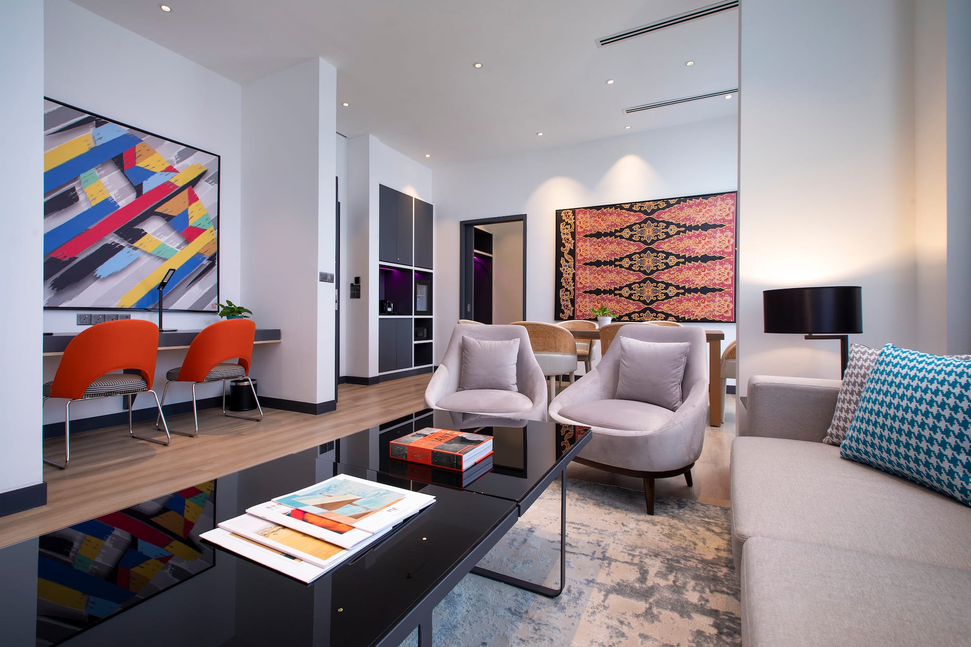 a room with a black coffee table and chairs