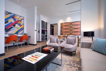 a room with a black coffee table and chairs