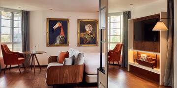 a room with a bed and a television