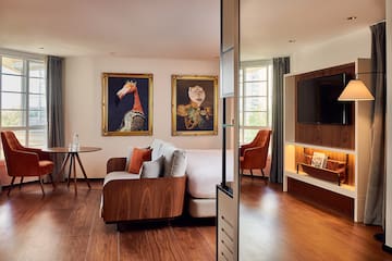 a room with a bed and a television