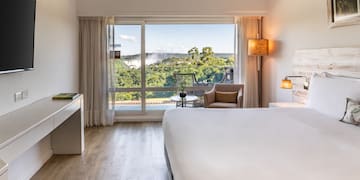 a room with a bed and a desk and a chair