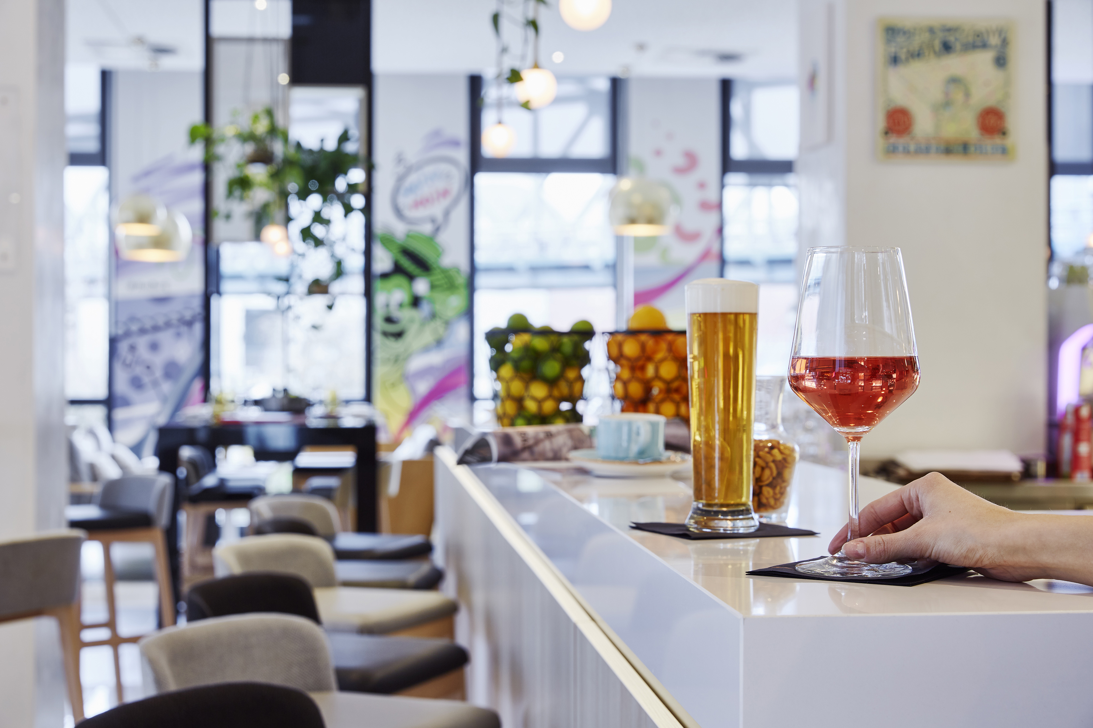 a hand holding a glass of wine