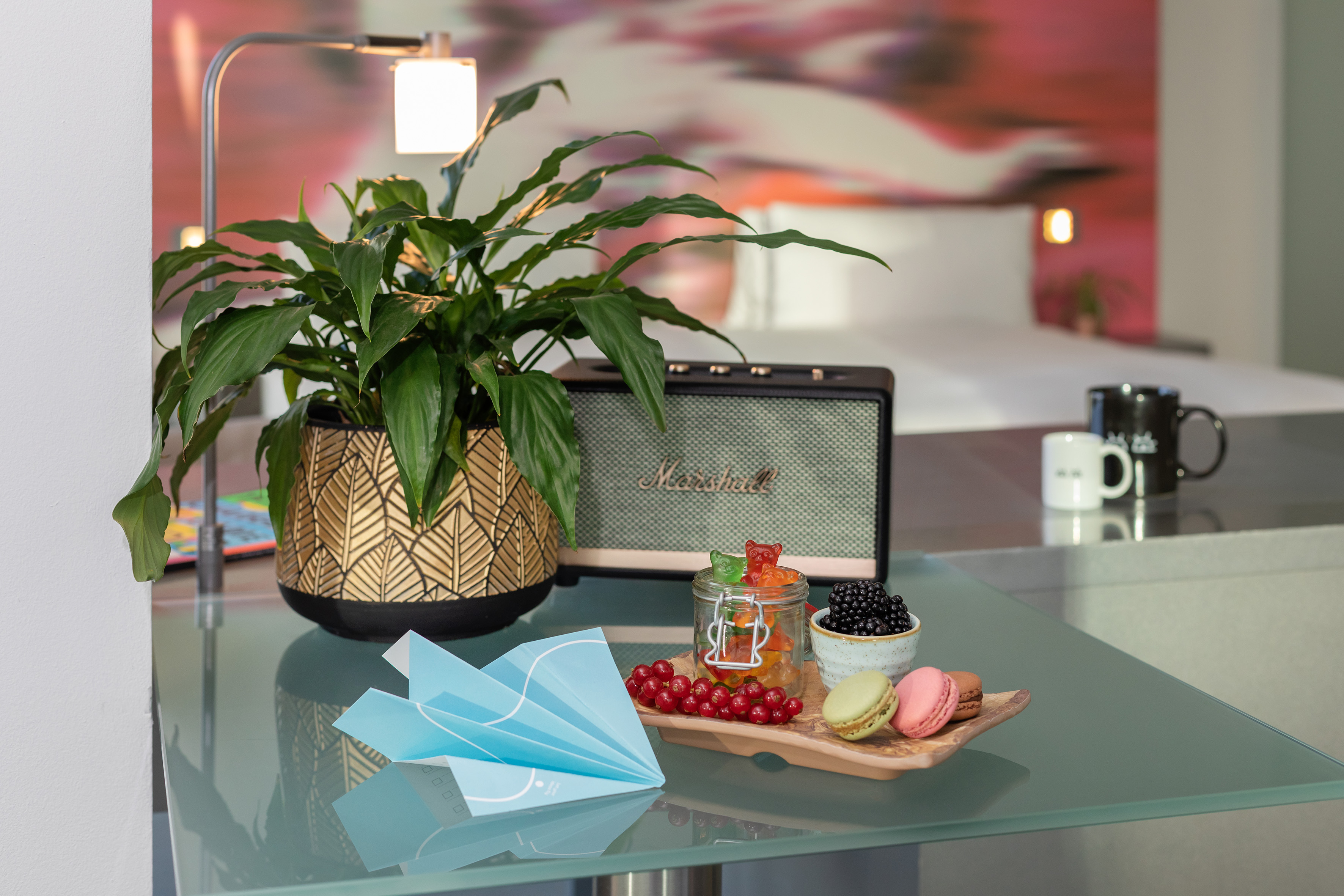 a table with a plant and a plate of food on it