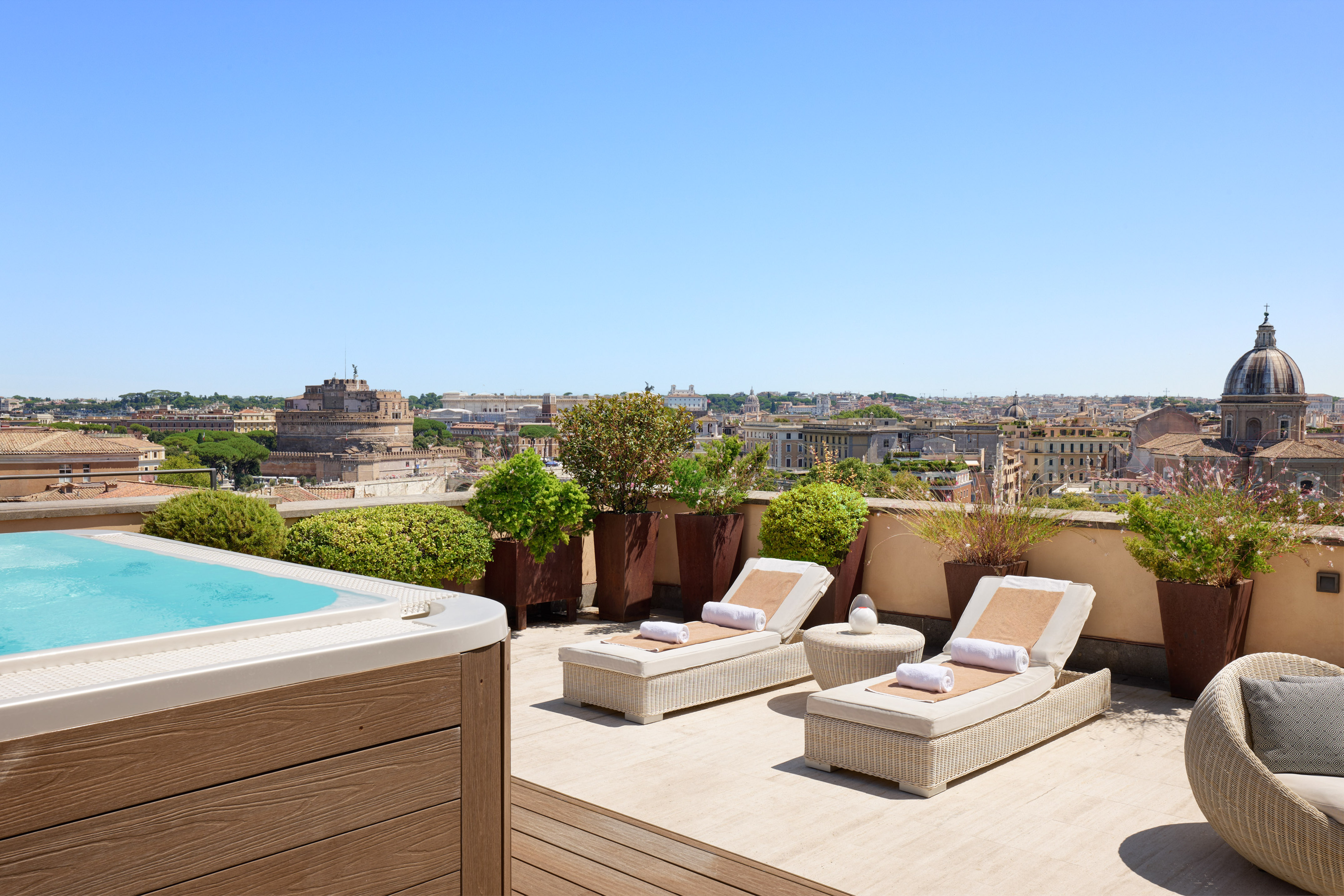 Rooftop hot tub terrace overlooking Rome, Castel Sant'Angelo, and city skyline.