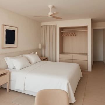 a bedroom with a bed and a ceiling fan