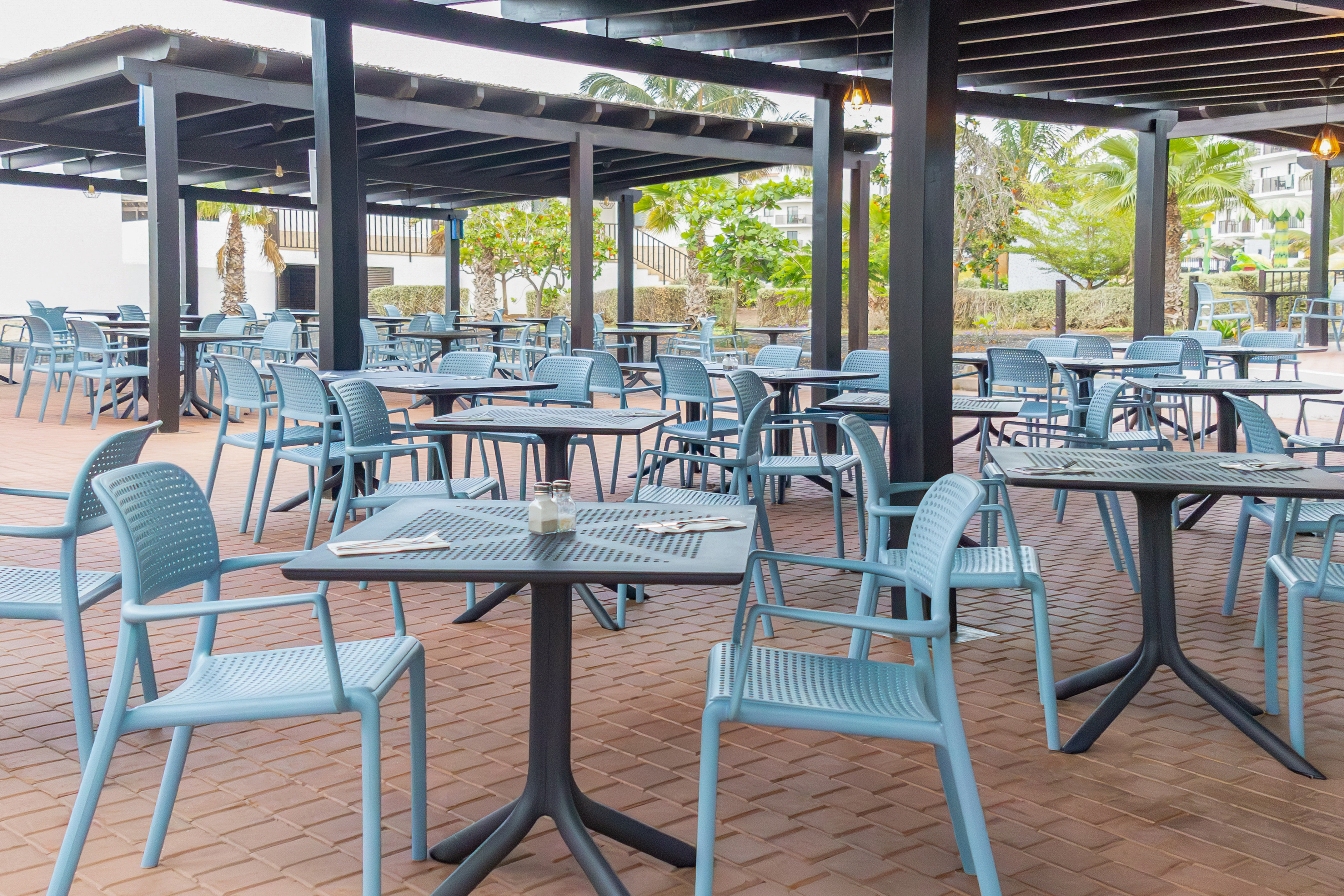 tables and chairs under a covered patio