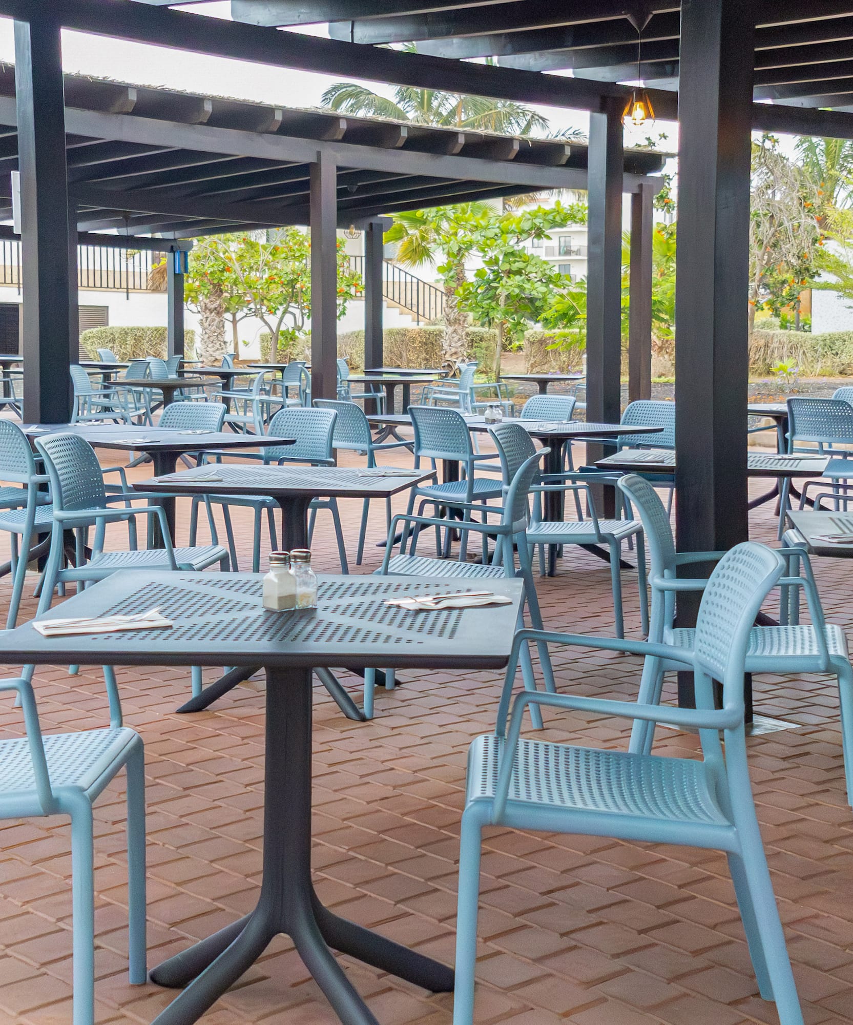 tables and chairs under a covered patio