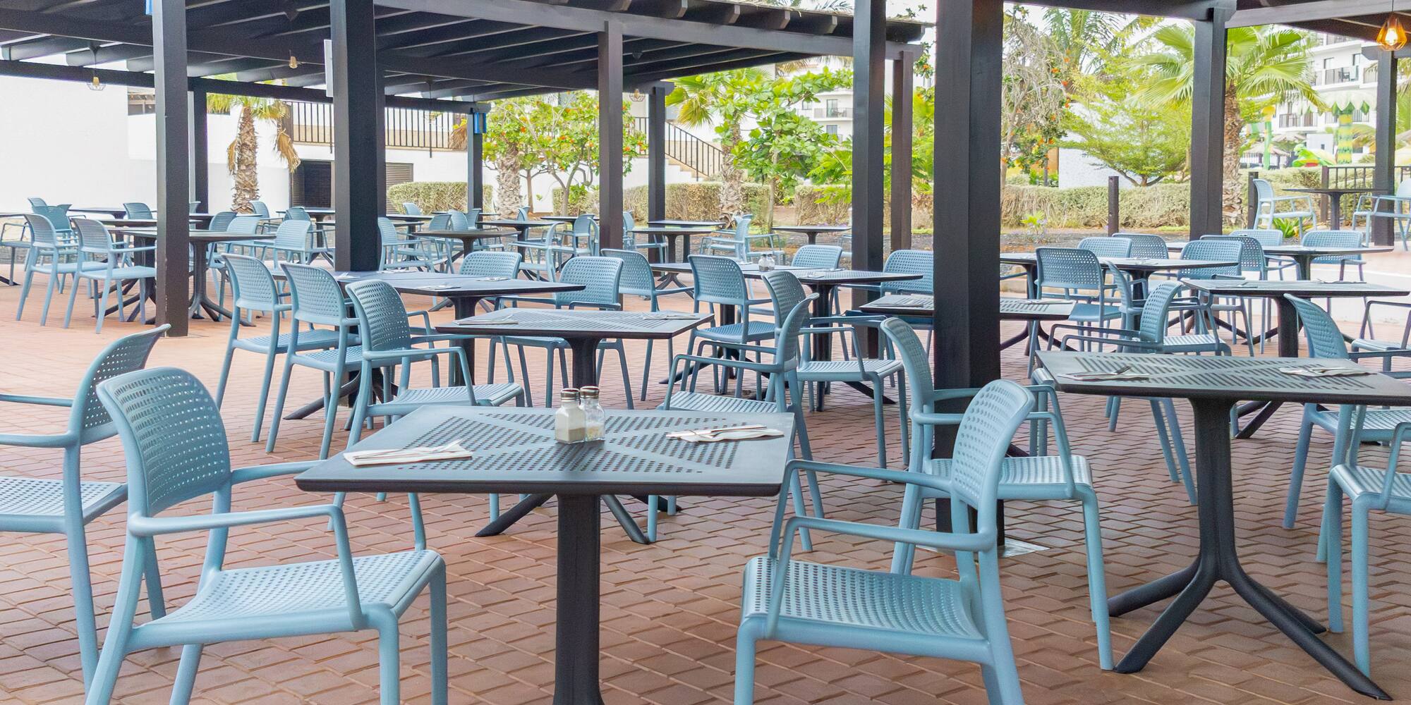 tables and chairs under a covered patio