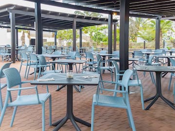 tables and chairs under a covered patio