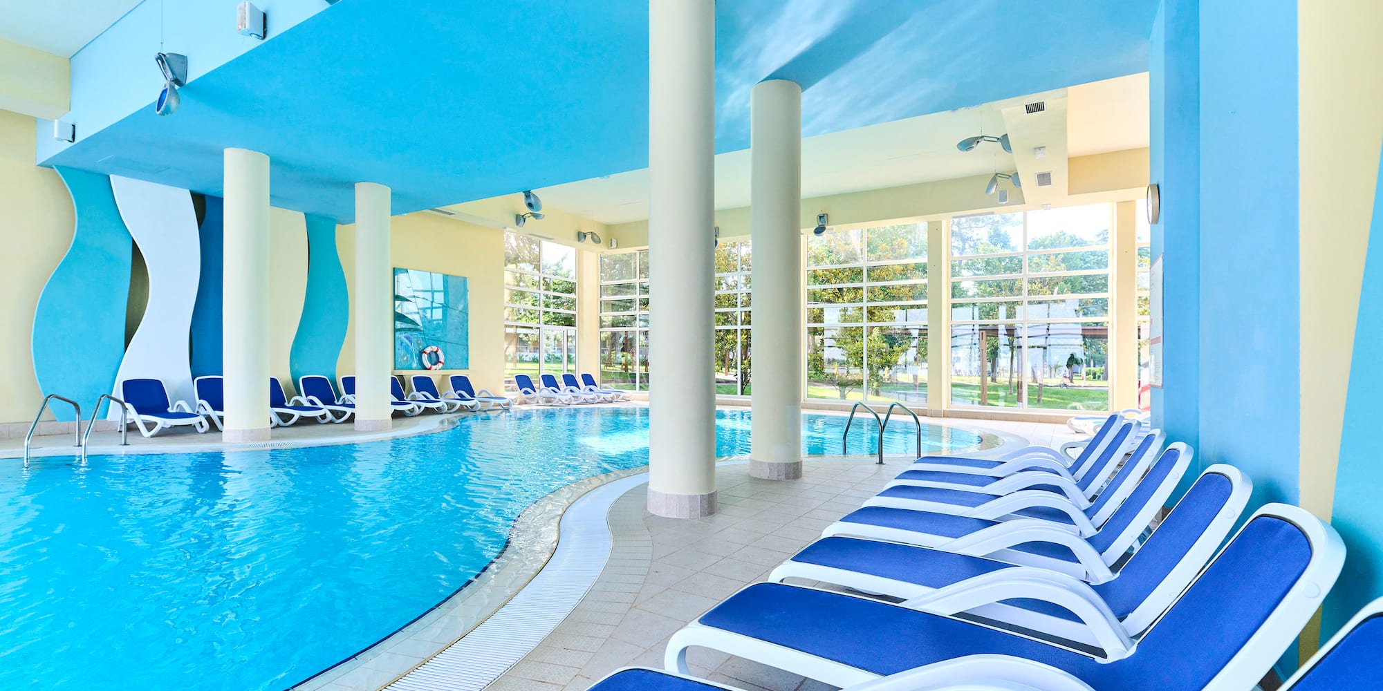 a pool with chairs and a large pool