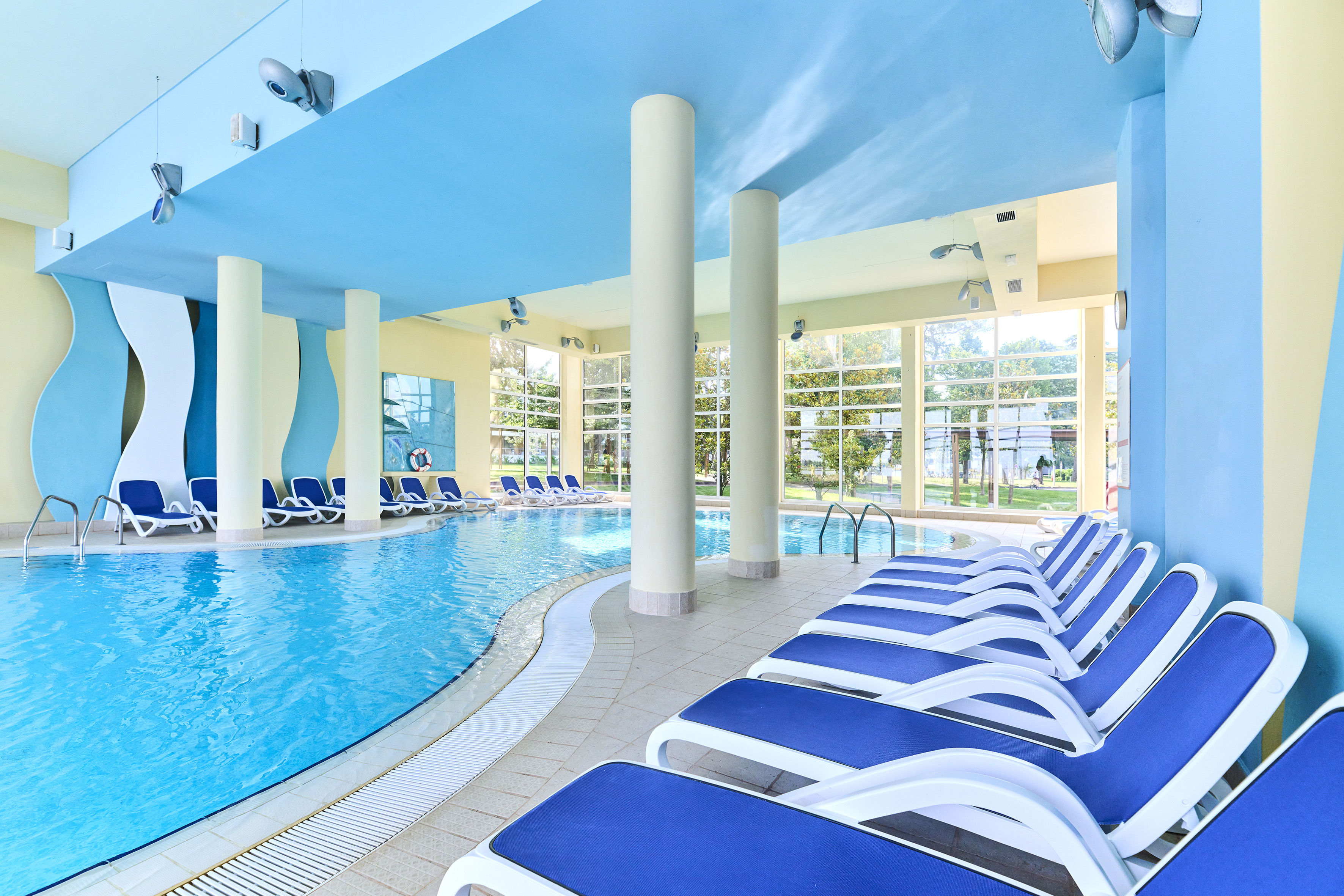 a pool with chairs and a large pool