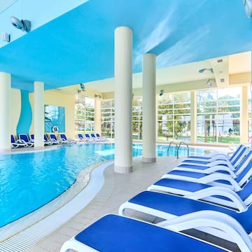 a pool with chairs and a large pool