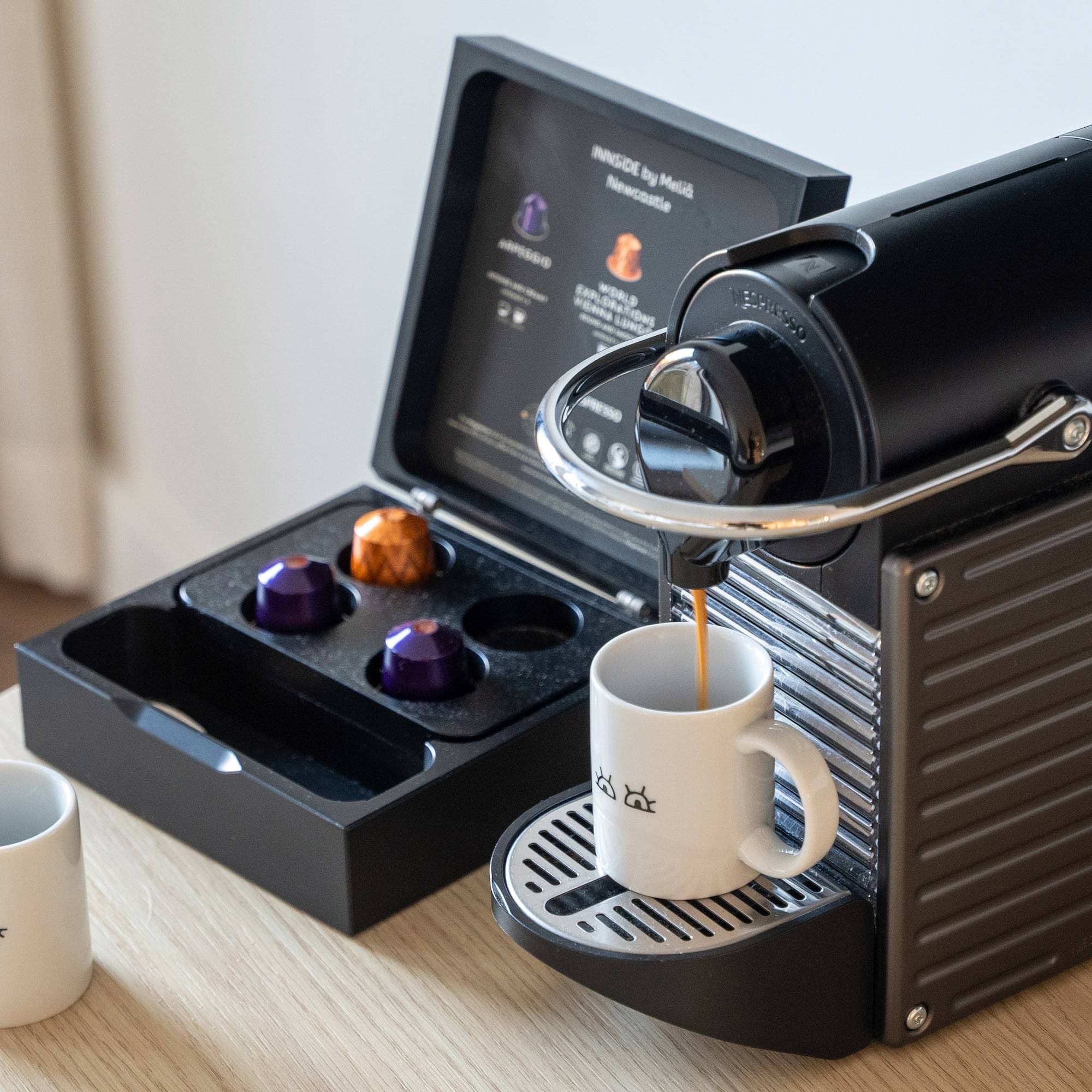 a coffee machine with a cup of coffee