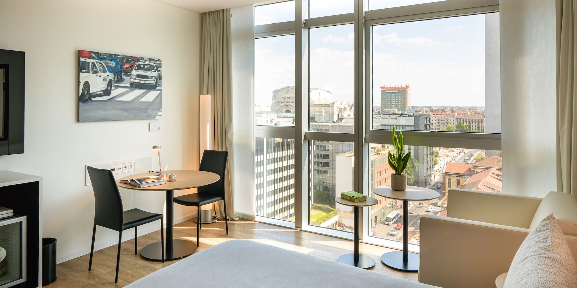 a room with a bed and chairs and a table