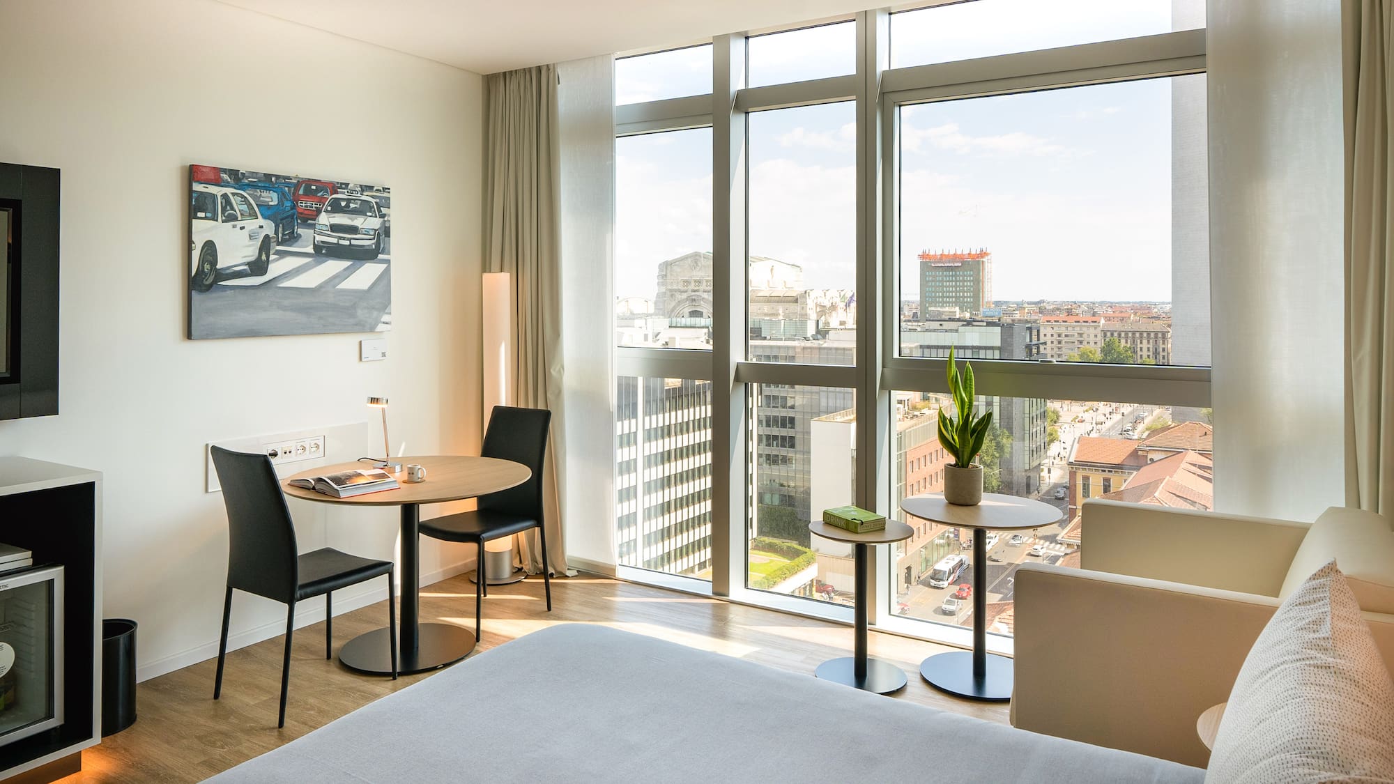 a room with a bed and chairs and a table