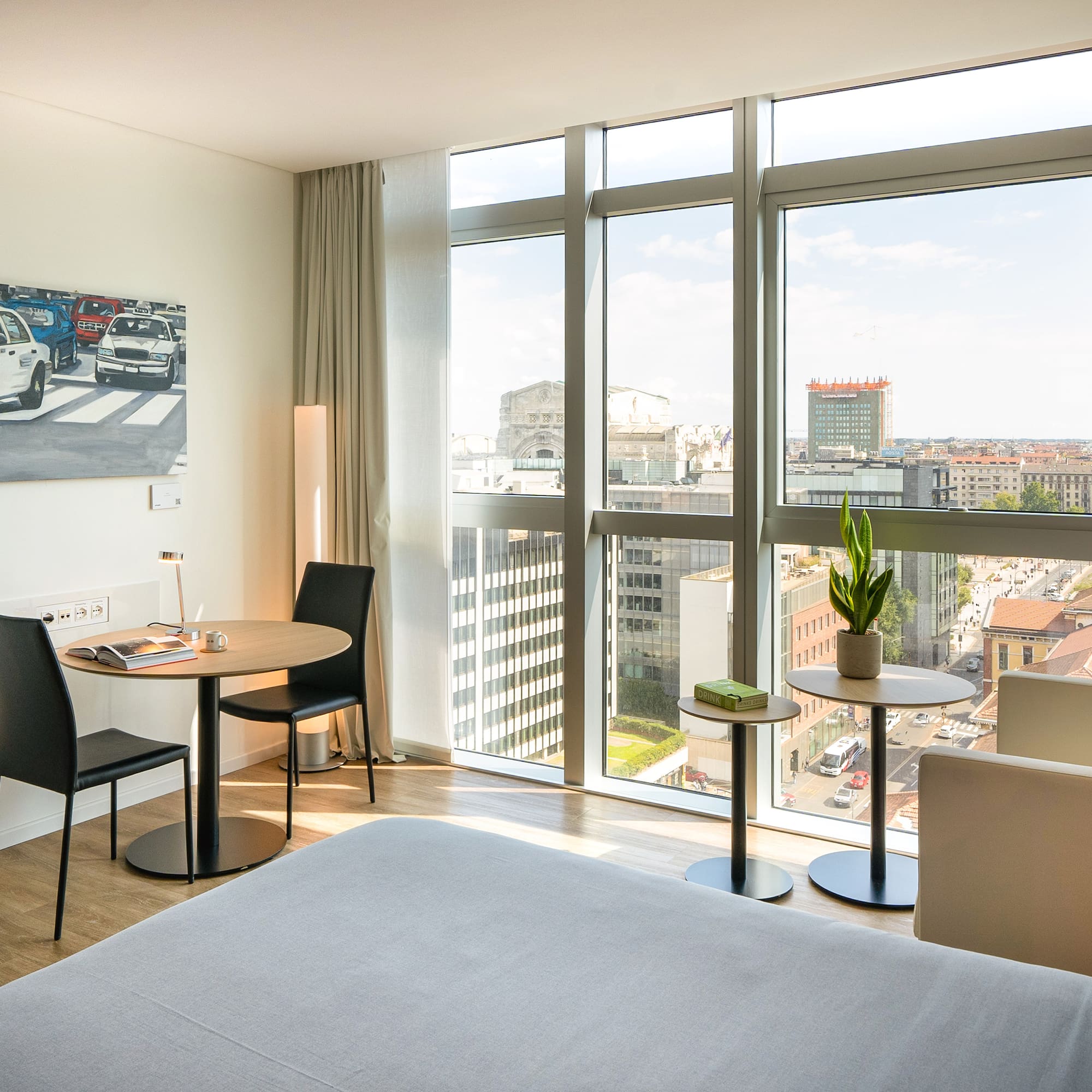 a room with a bed and chairs and a table