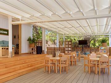 a room with wooden chairs and a white roof