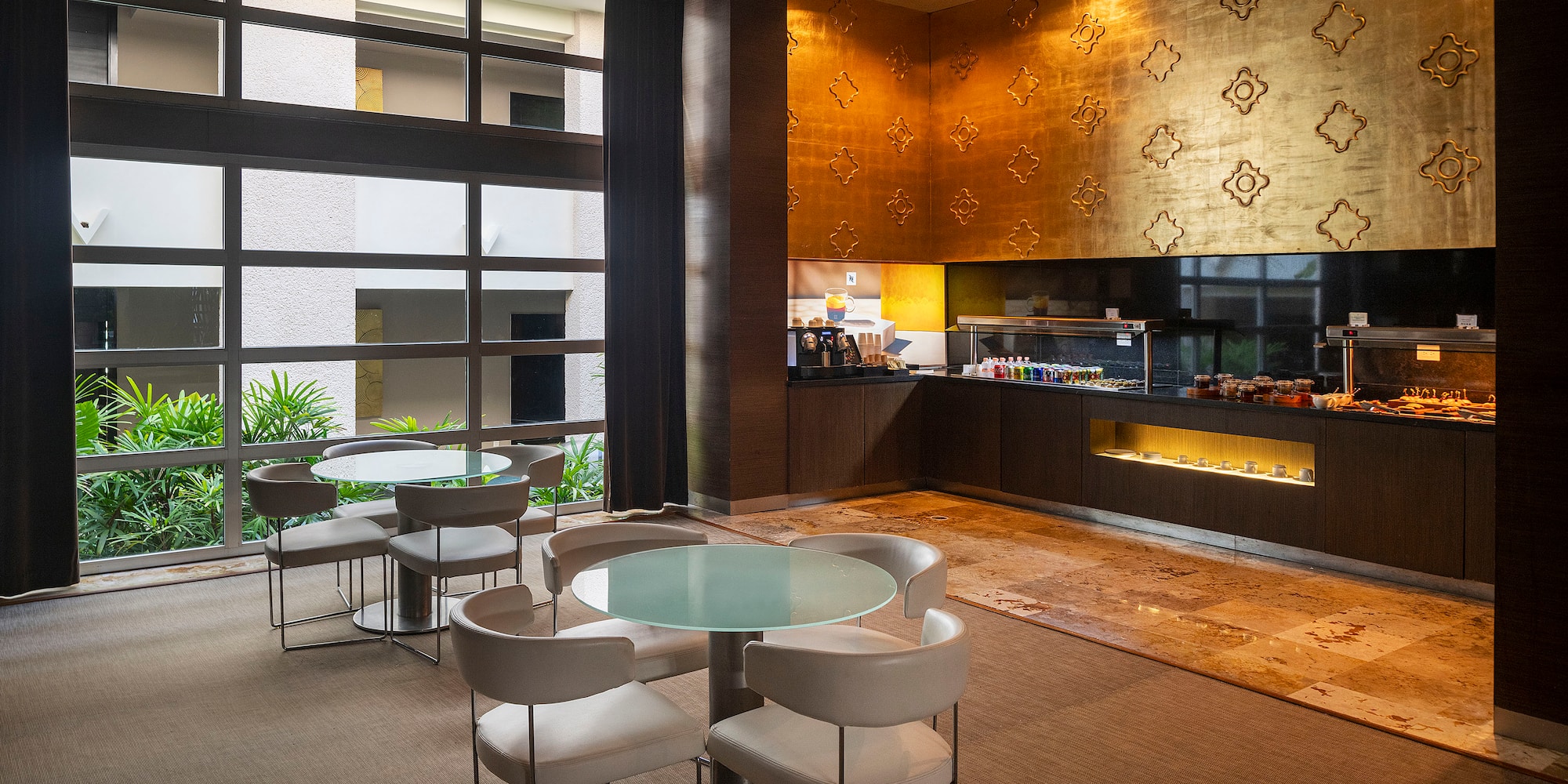 a room with a glass table and chairs