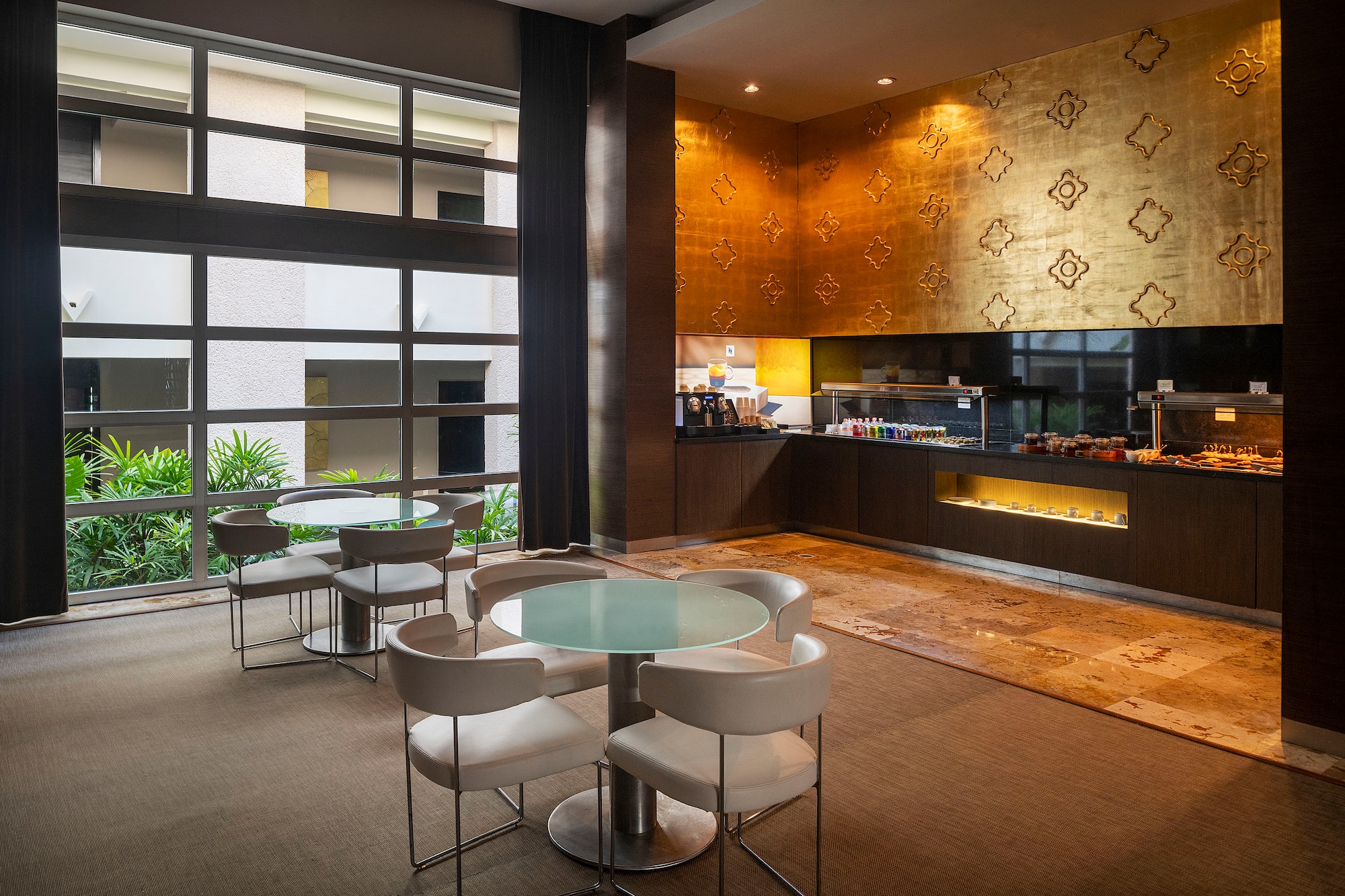 a room with a glass table and chairs