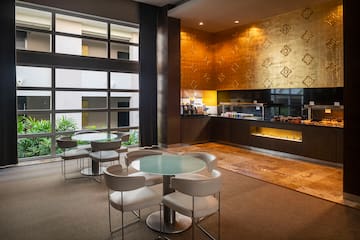 a room with a glass table and chairs