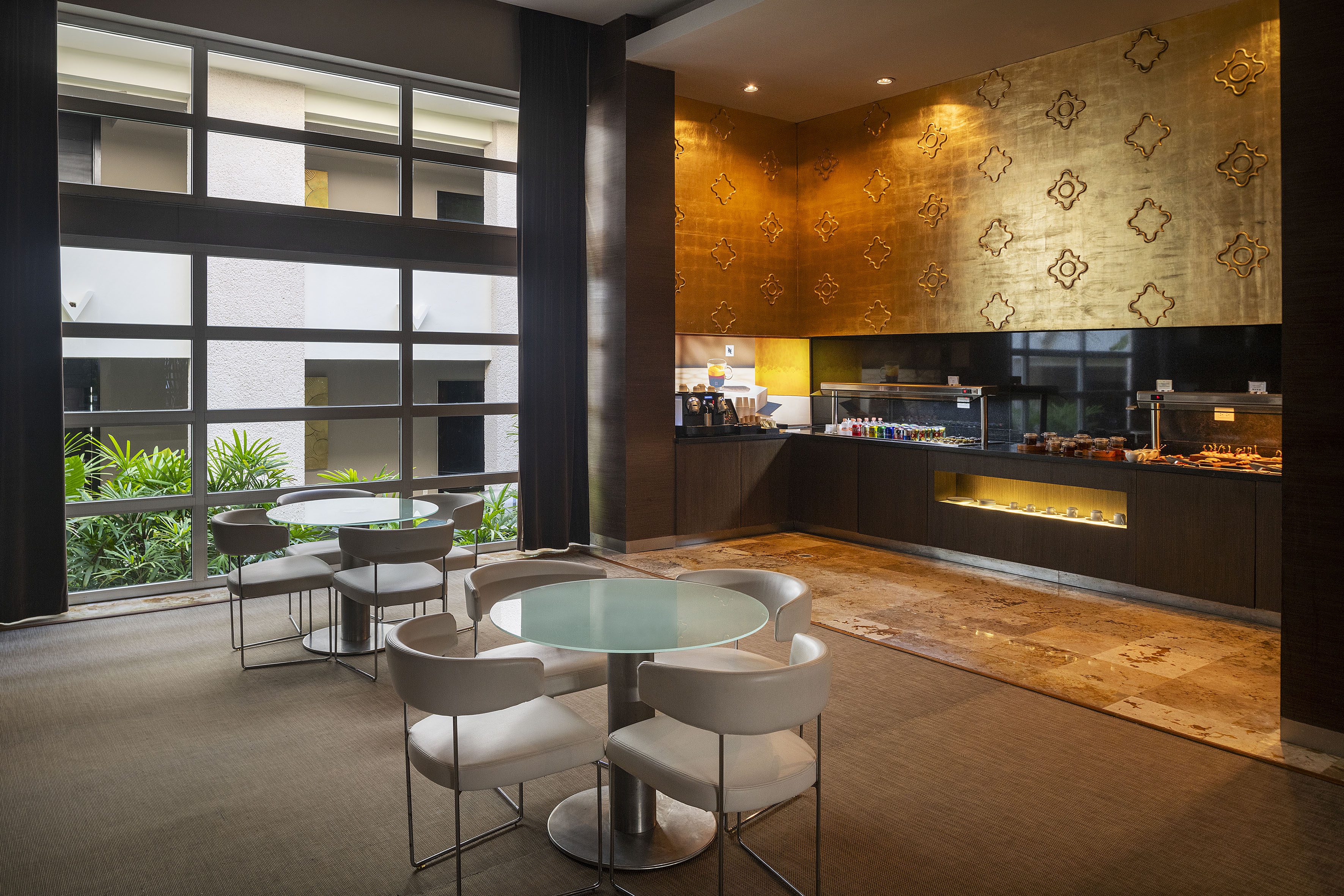 a room with a glass table and chairs