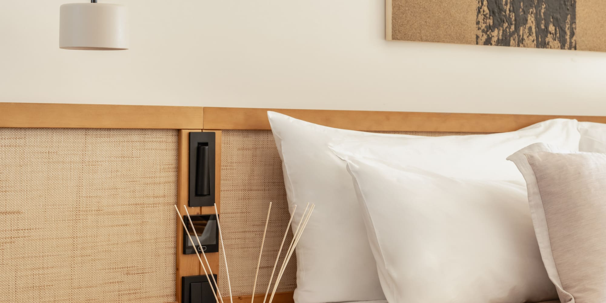 a bed with pillows and a lamp