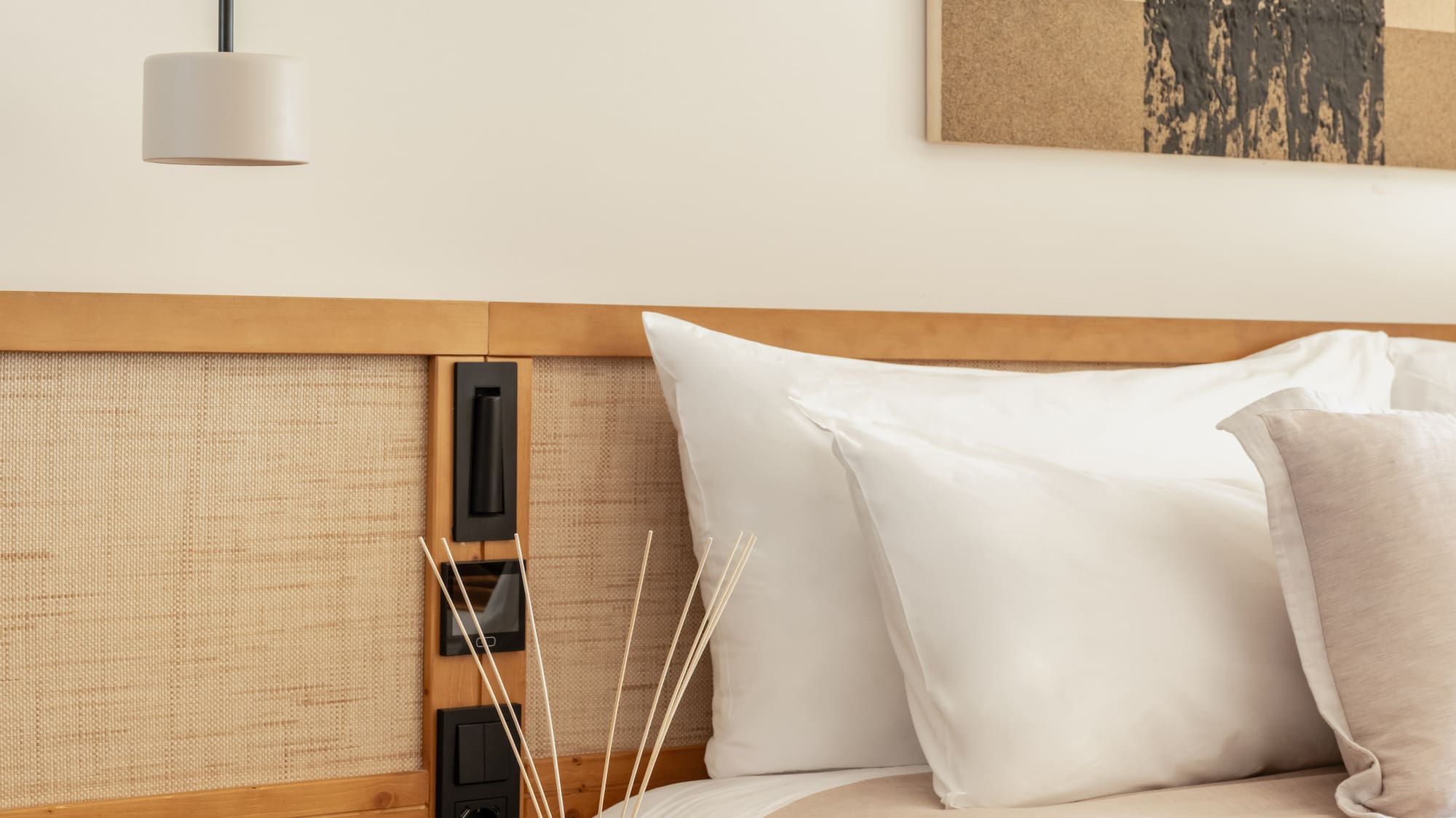 a bed with pillows and a lamp