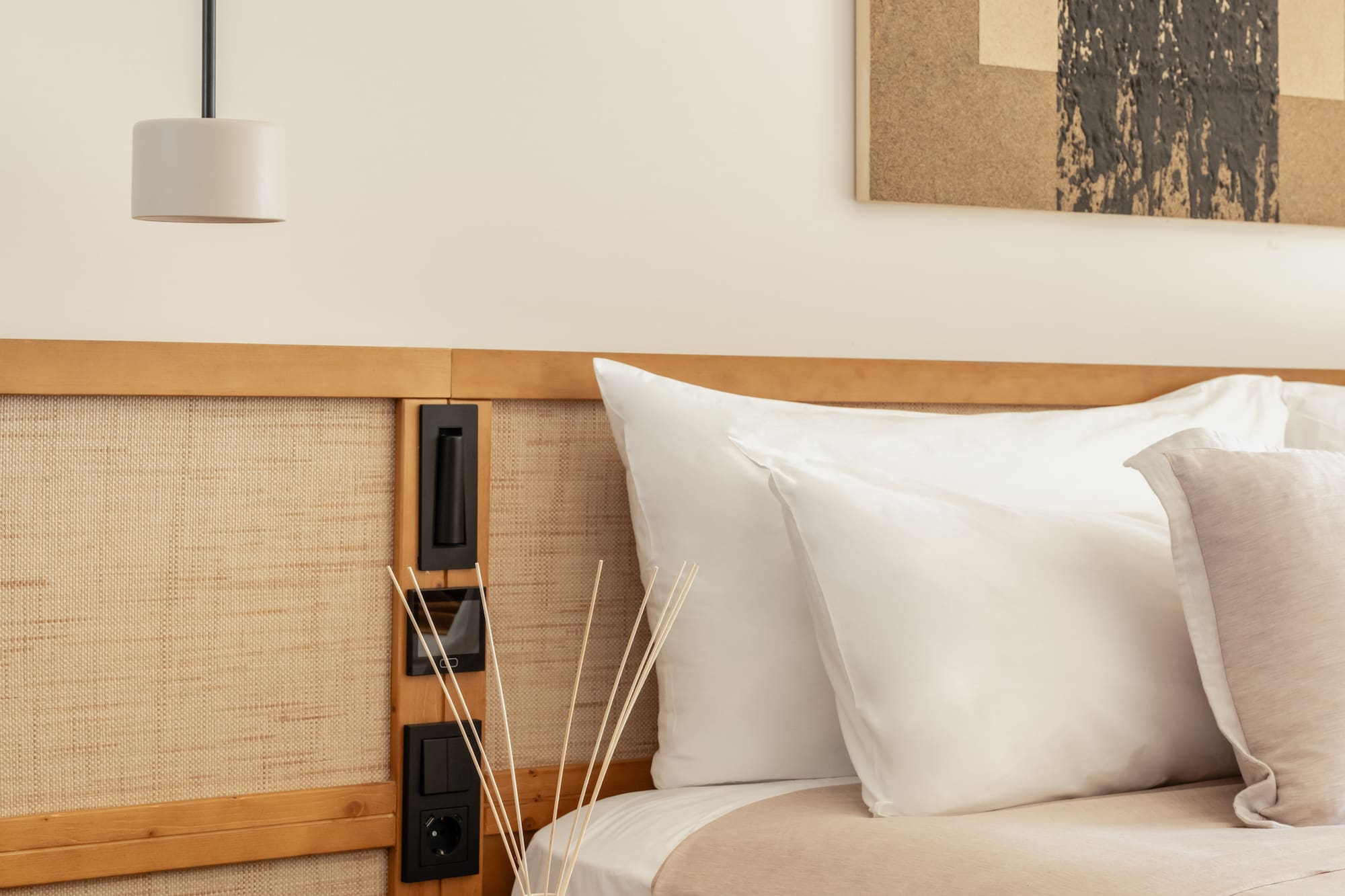 a bed with pillows and a lamp