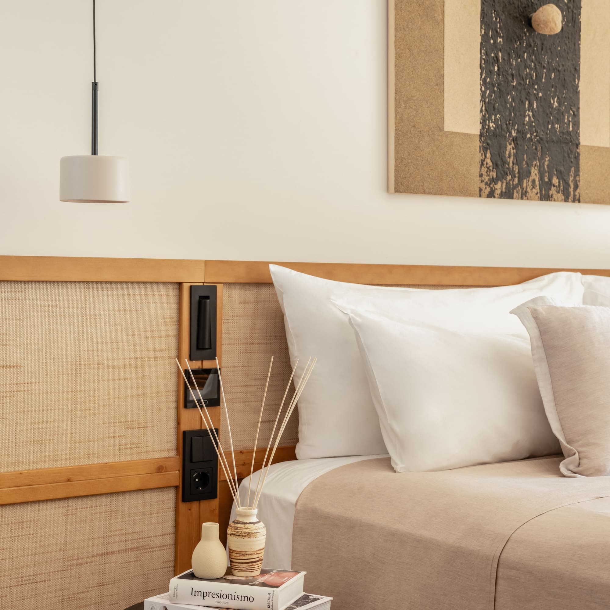 a bed with pillows and a lamp