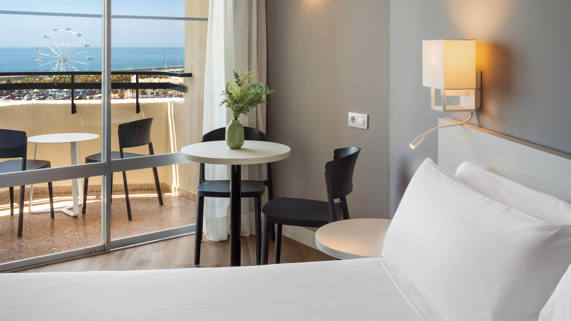 a room with a bed and table and chairs